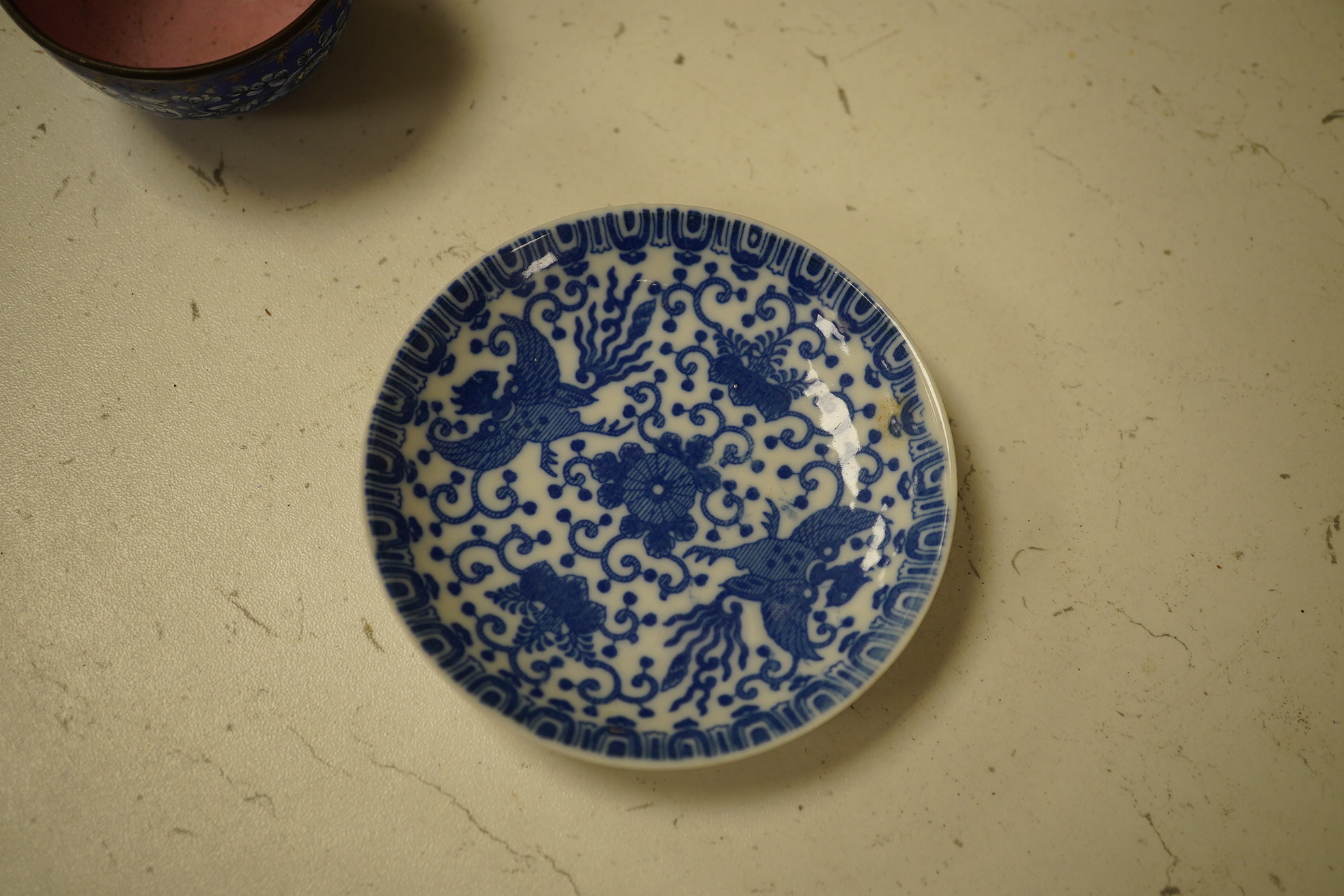 A group of Chinese blue and white porcelain, including a mid 19th century Canton enamel teabowl and a Japanese small dish, tallest 22cm. Condition - fair